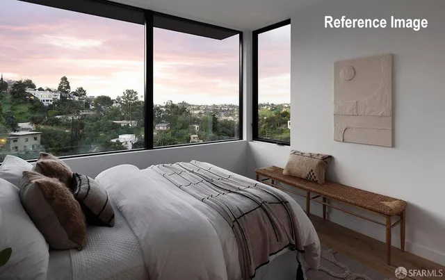 a bed sitting in a bedroom next to a window