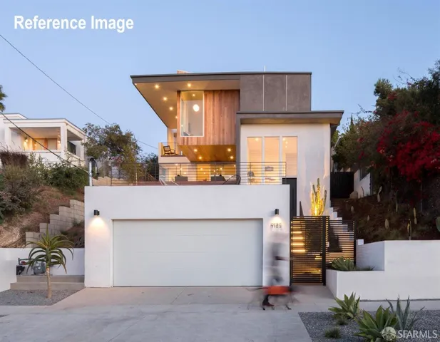 a view of a house with a patio and a yard