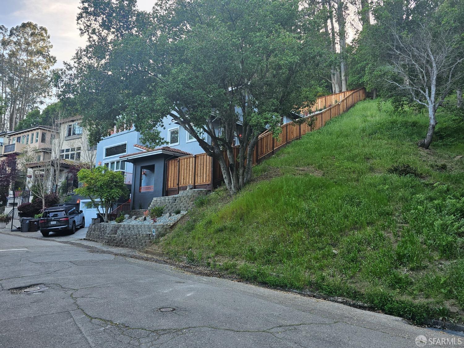 7003 Buckingham Boulevard Berkeley, CA 94705 - Photo 6 of 8 a view of a patio with couches and a table and chairs with plants and trees
