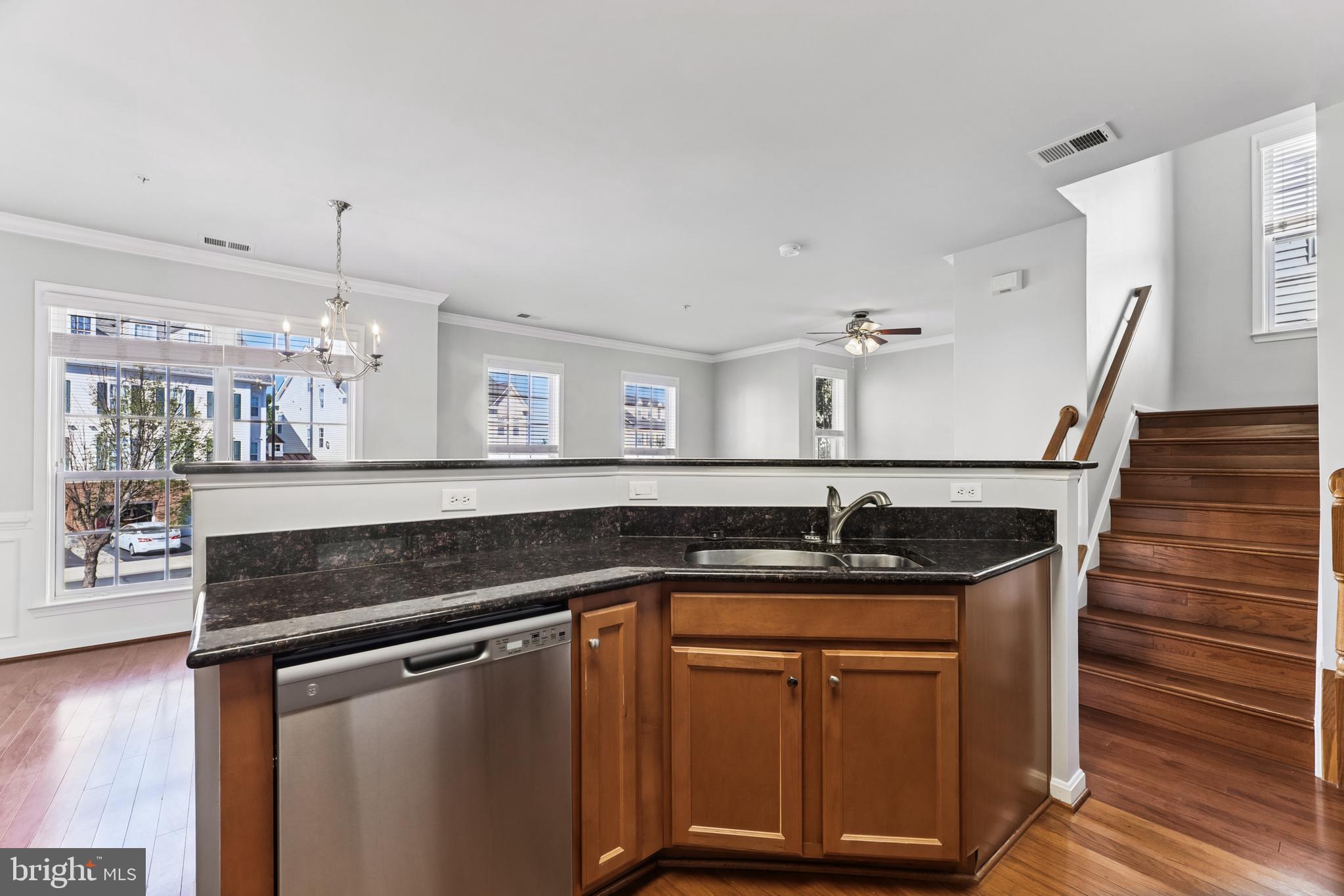 6821 Hampton Bay Lane Gainesville, VA 20155 - Photo 16 of 29 a kitchen with granite countertop a sink and chandelier