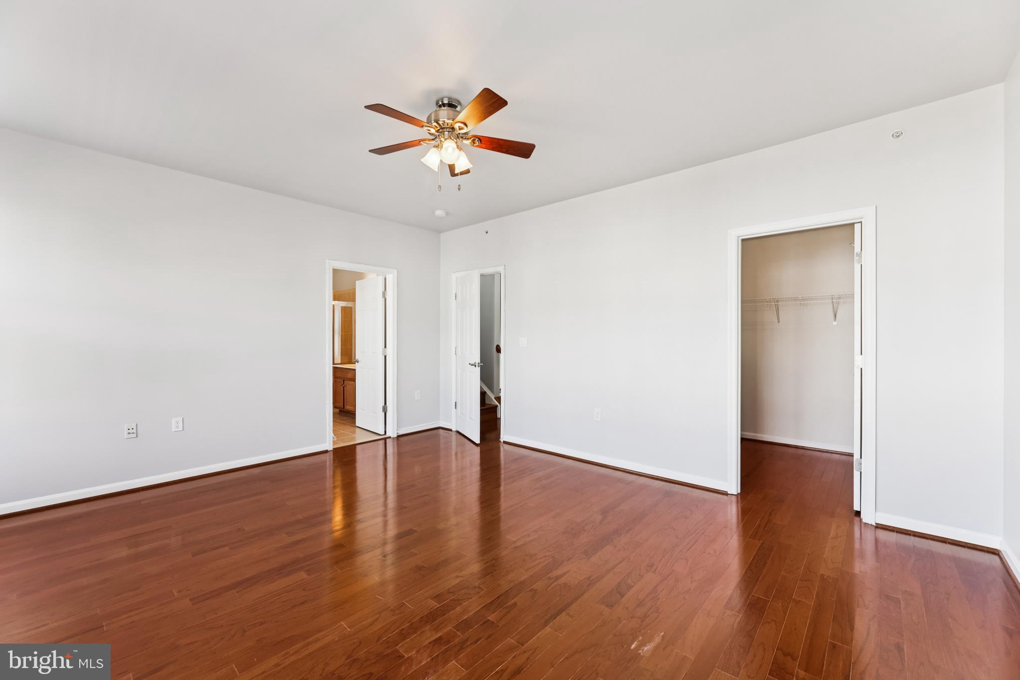 6821 Hampton Bay Lane Gainesville, VA 20155 - Photo 19 of 29 a view of an empty room with wooden floor and a ceiling fan