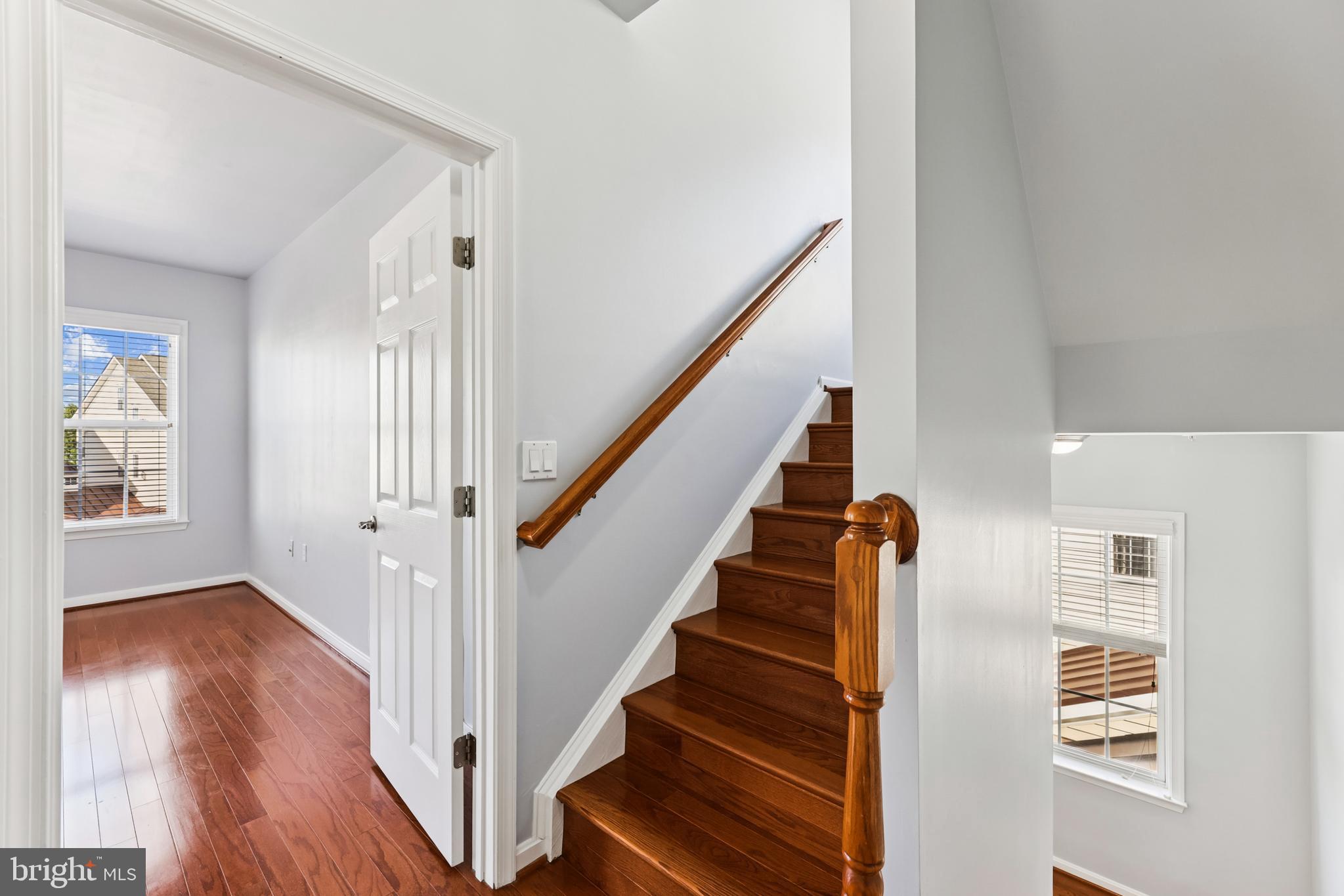6821 Hampton Bay Lane Gainesville, VA 20155 - Photo 25 of 29 a view of staircase with wooden floor and a rug