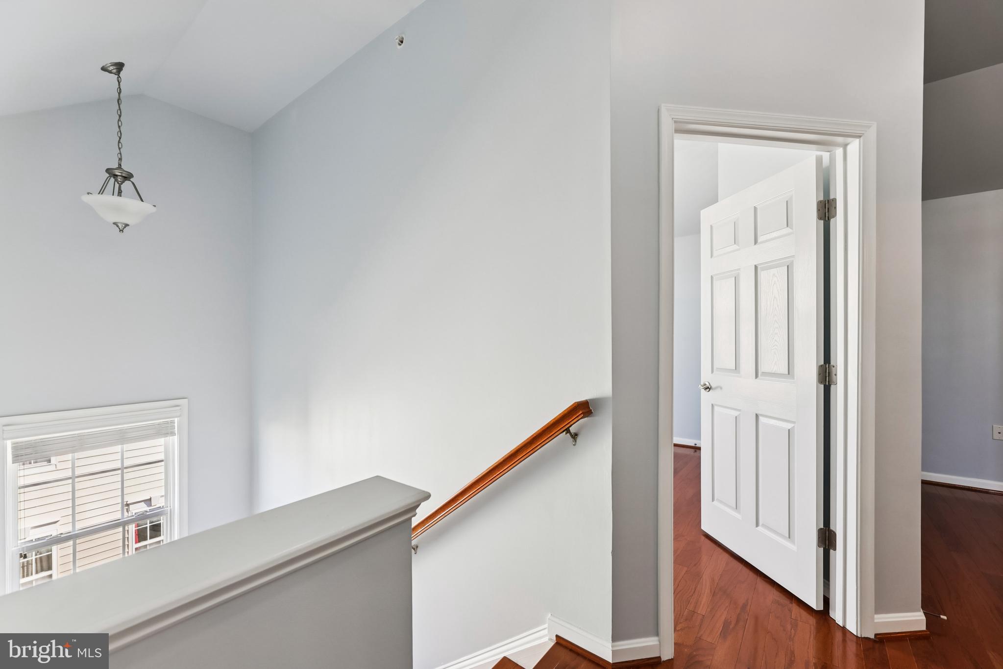 6821 Hampton Bay Lane Gainesville, VA 20155 - Photo 26 of 29 a view of a hallway with wooden floor and staircase
