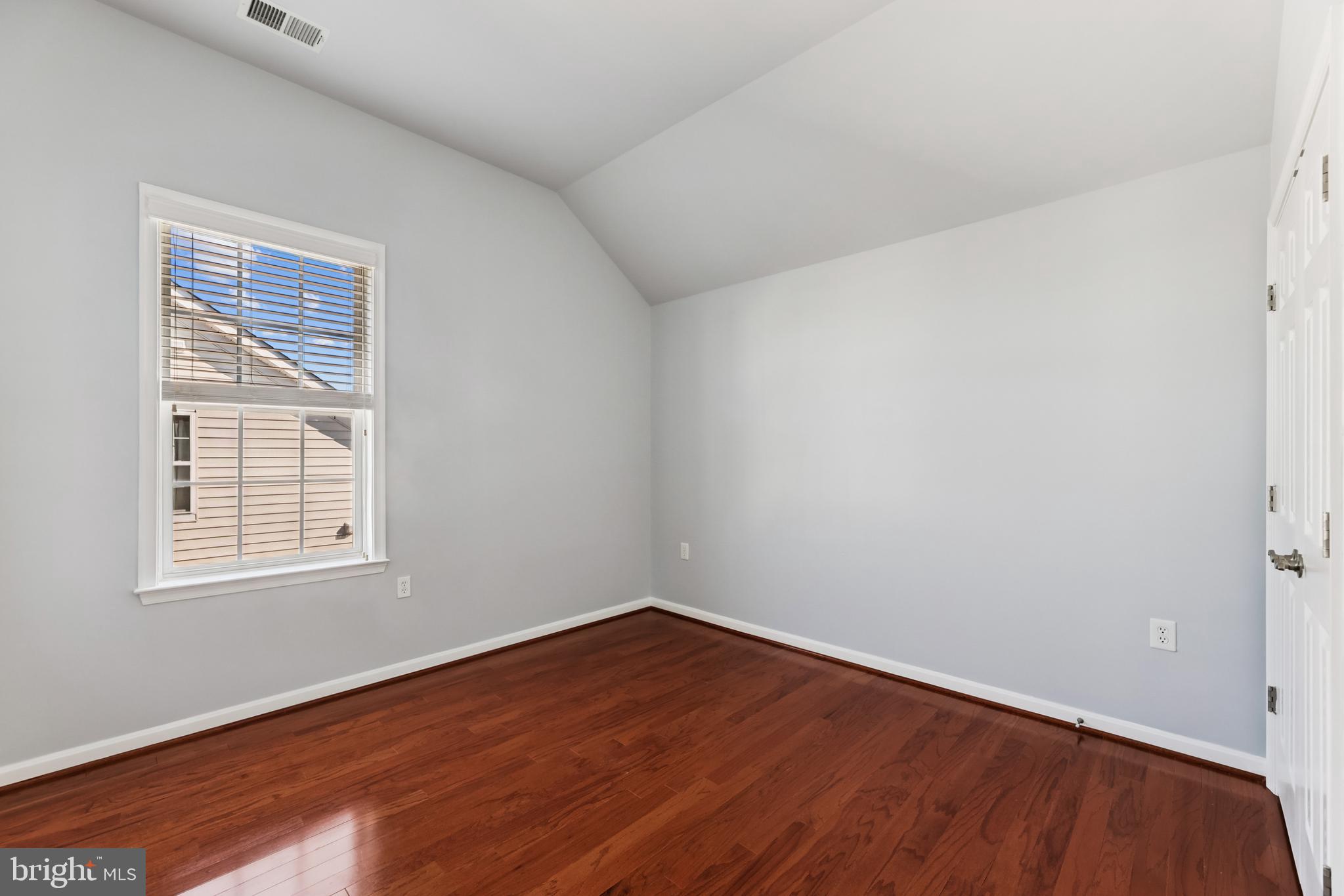 6821 Hampton Bay Lane Gainesville, VA 20155 - Photo 27 of 29 an empty room with wooden floor and windows