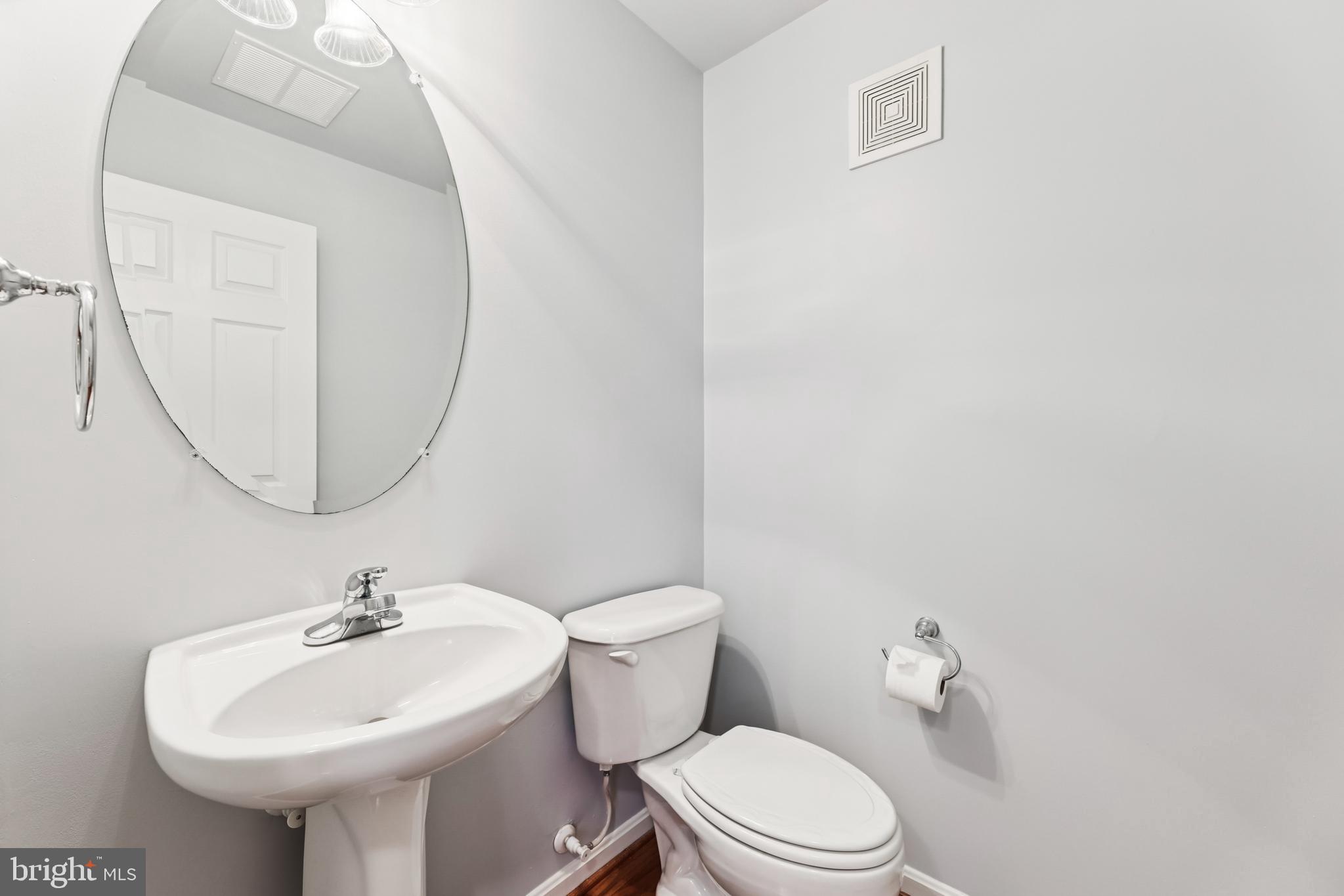 6821 Hampton Bay Lane Gainesville, VA 20155 - Photo 6 of 29 a bathroom with a sink a mirror and a toilet