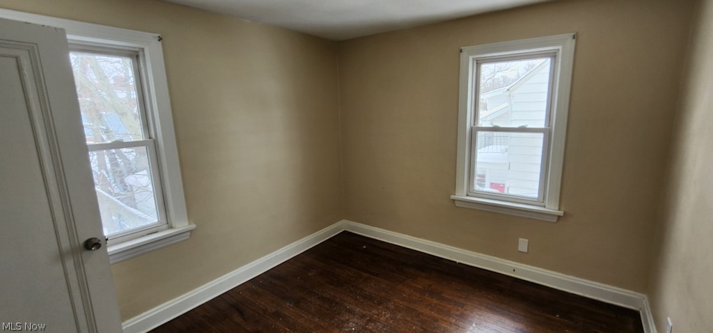 3599 Grosvenor Road Cleveland, OH 44118 - Photo 13 of 25 Spare room with dark wood finished floors and healthy amount of natural light