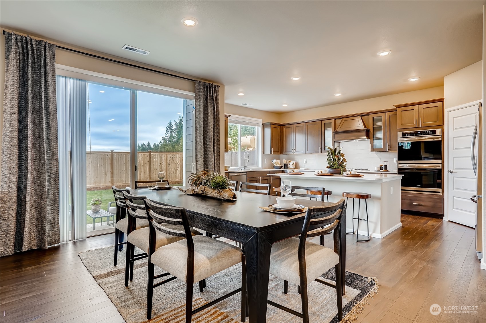23417 41st Drive Southeast, Unit 29 Bothell, WA 98021 - Photo 9 of 24 a view of a dining room with furniture and wooden floor