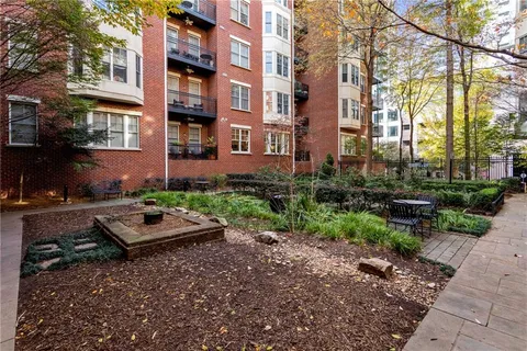 a view of a backyard with plants and outdoor seating