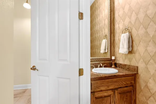 a bathroom with a sink vanity and a mirror