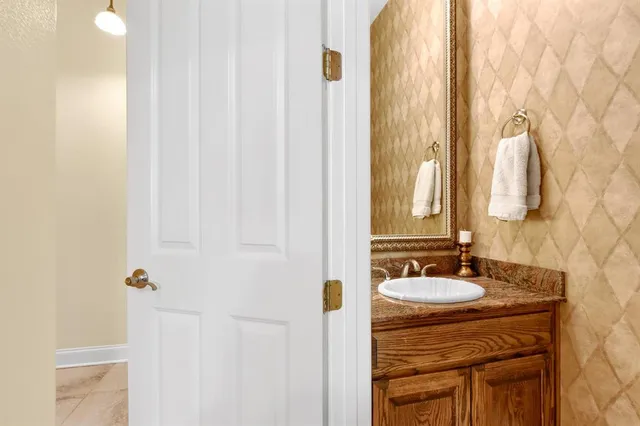 a bathroom with a sink vanity and a mirror