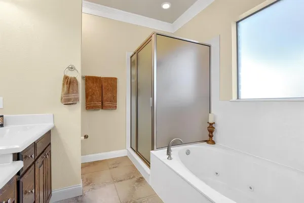 a bathroom with a tub sink and mirror