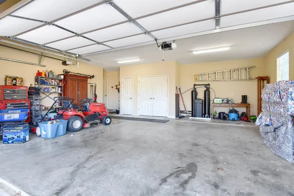 a view of a garage with a bike and a car