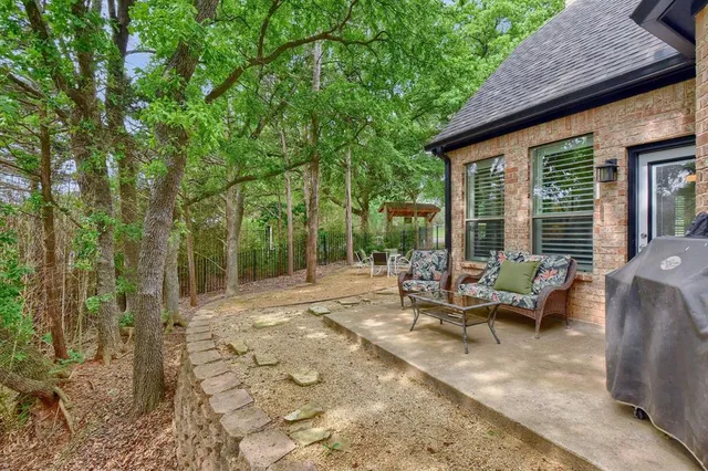 a view of a patio with table and chairs and floor to ceiling window