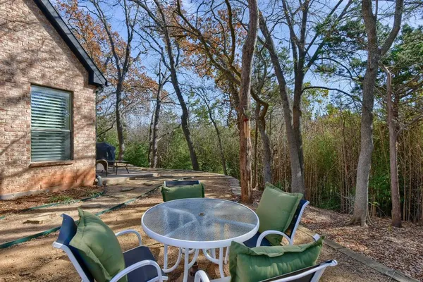 a backyard of a house with table and chairs