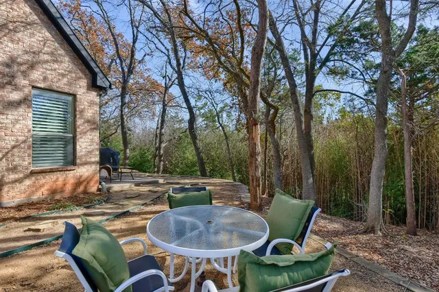a backyard of a house with table and chairs