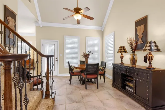a dining room with furniture and chandelier