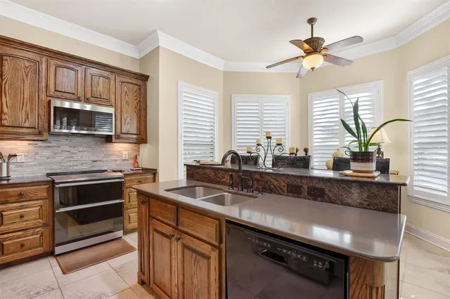 a kitchen with stainless steel appliances a sink stove and microwave