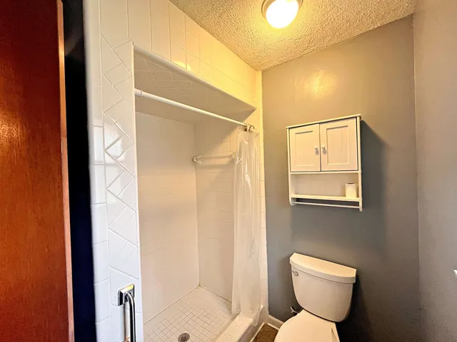 a bathroom with a toilet sink and shower