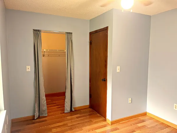 a view of a livingroom with wooden floor and closet