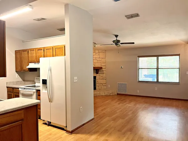 a view of kitchen with stainless steel appliances a stove a refrigerator and a window