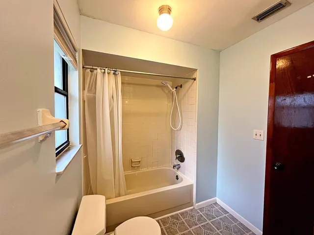 a bathroom with a shower and a toilet
