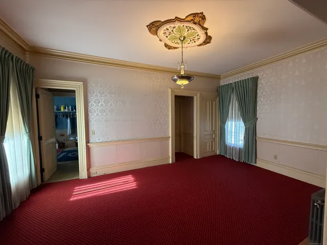 a room with chairs and windows