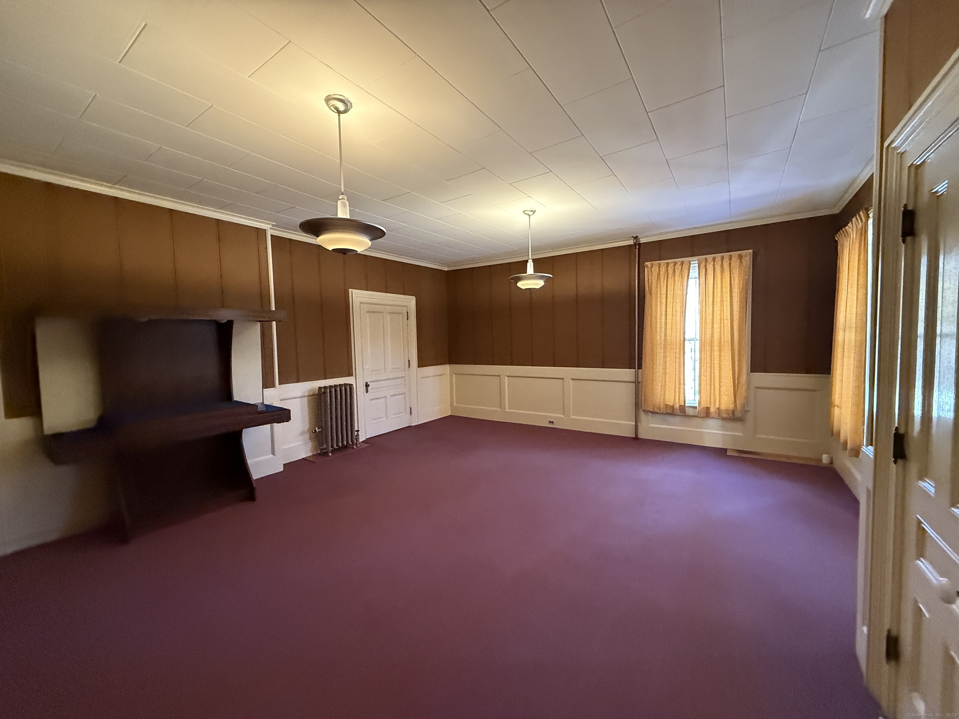 55 Walnut Street Winchester, CT 06098 - Photo 23 of 37 an empty room with windows and fireplace