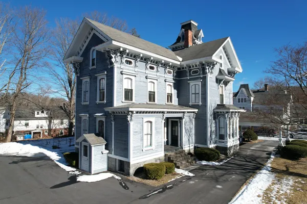 a front view of a building with parking area