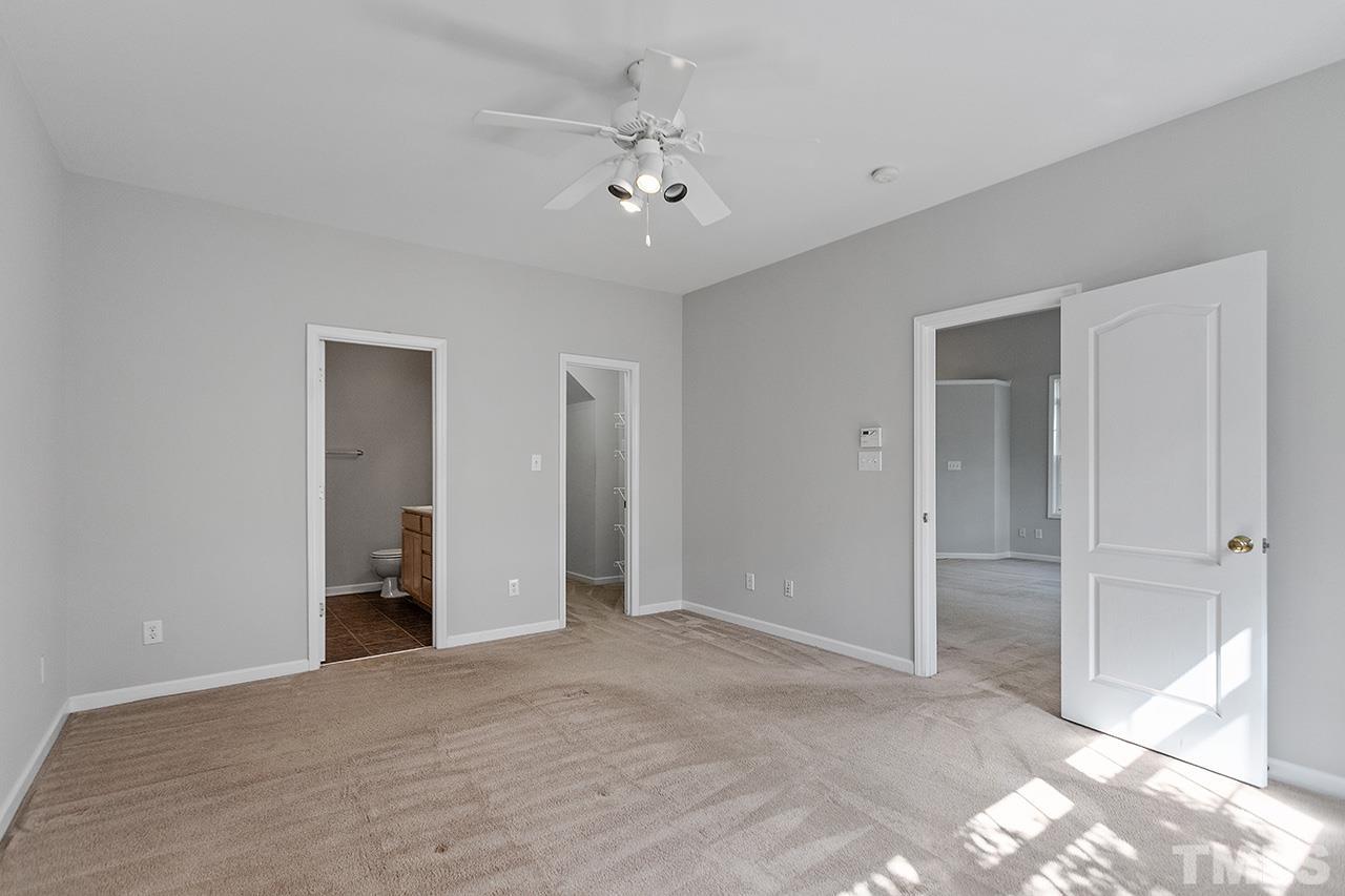 1401 Basinger Court Raleigh, NC 27612 - Photo 16 of 32 a view of an empty room with a ceiling fan
