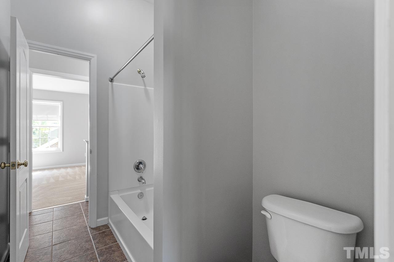 1401 Basinger Court Raleigh, NC 27612 - Photo 30 of 32 a bathroom with a toilet and a tub