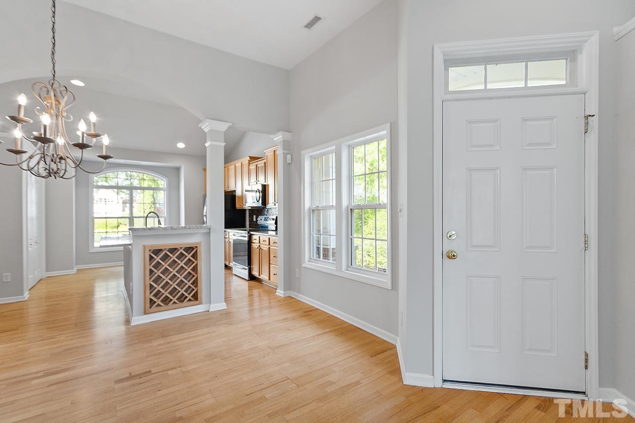 1401 Basinger Court Raleigh, NC 27612 - Photo 7 of 32 a view of an empty room with a window and wooden floor