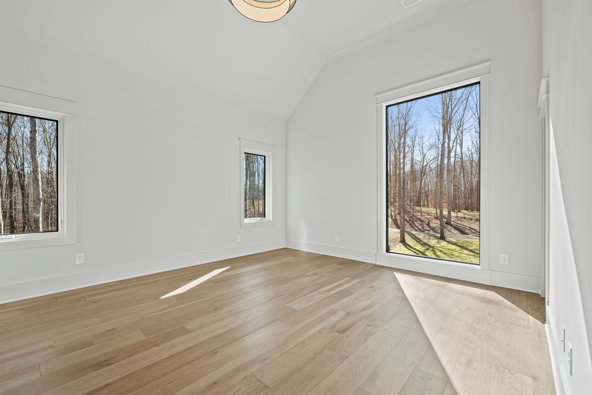 5896 Pinewood Road Franklin, TN 37064 - Photo 51 of 66 a view of an empty room with a window and wooden floor