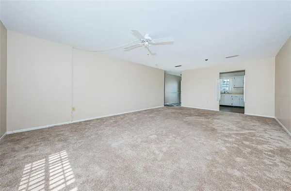 a view of an empty room with a ceiling fan