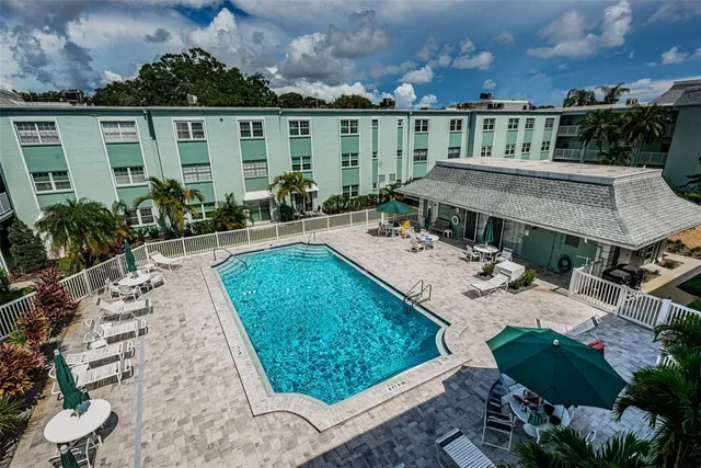 a view of a patio with couches chairs and potted plants