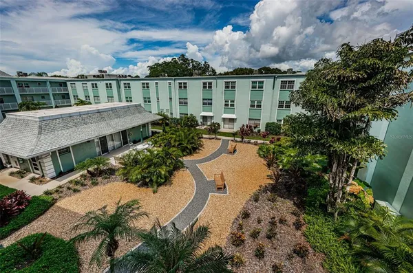 an aerial view of a house with a yard basket ball court and outdoor seating