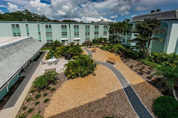 an aerial view of a house with a yard and potted plants