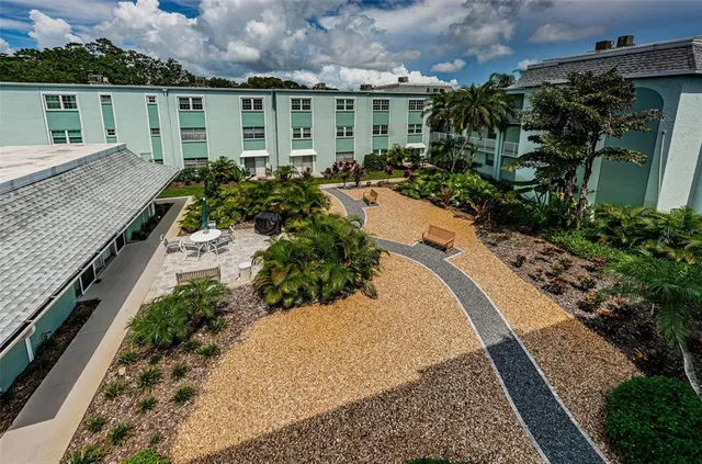 an aerial view of a house with a yard and potted plants