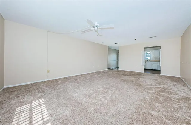 a view of an empty room with a ceiling fan