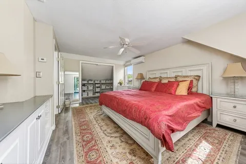 a bedroom with a large bed and a walk in closet