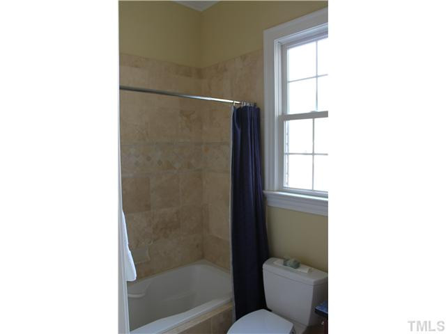2108 Tulare Court Raleigh, NC 27612 - Photo 12 of 25 off downstairs bedroom with travertine floor granite vanity top with ORB fixture Bathroom