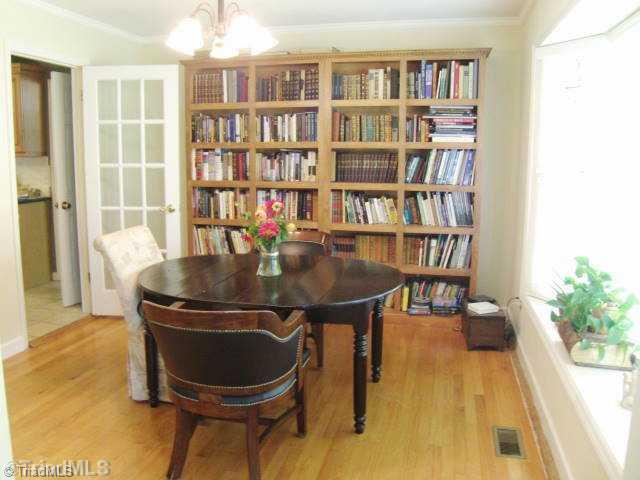 3205 Pine Needles Road High Point, NC 27265 - Photo 5 of 16 Dining Room. Spacious Dining Room with real hardwood floors, window seat, built in book cases and note the glass door into the kitchen