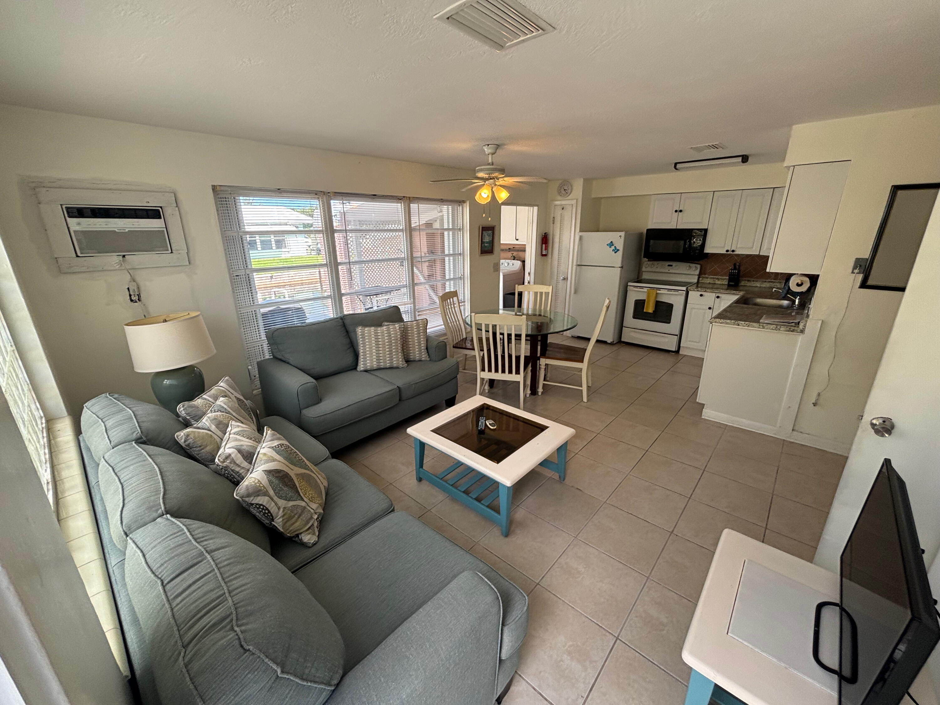 1433 Sunset Road Big Pine Key, FL 33043 - Photo 12 of 18 a living room with furniture a flat screen tv and a window
