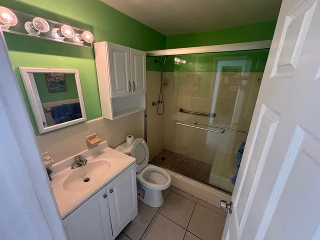 a bathroom with a sink mirror toilet and shower