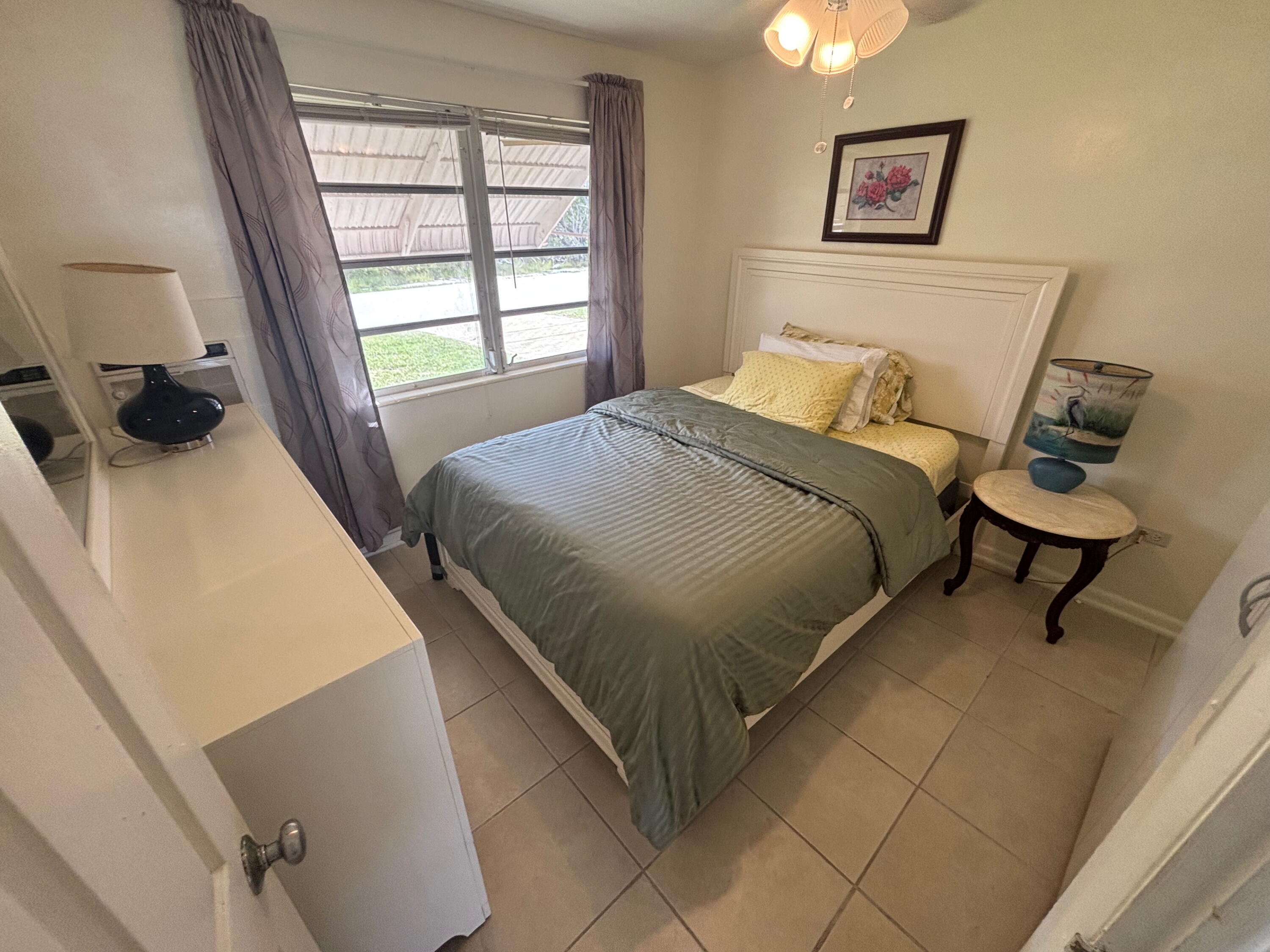 1433 Sunset Road Big Pine Key, FL 33043 - Photo 14 of 18 a bedroom with a bed and a window