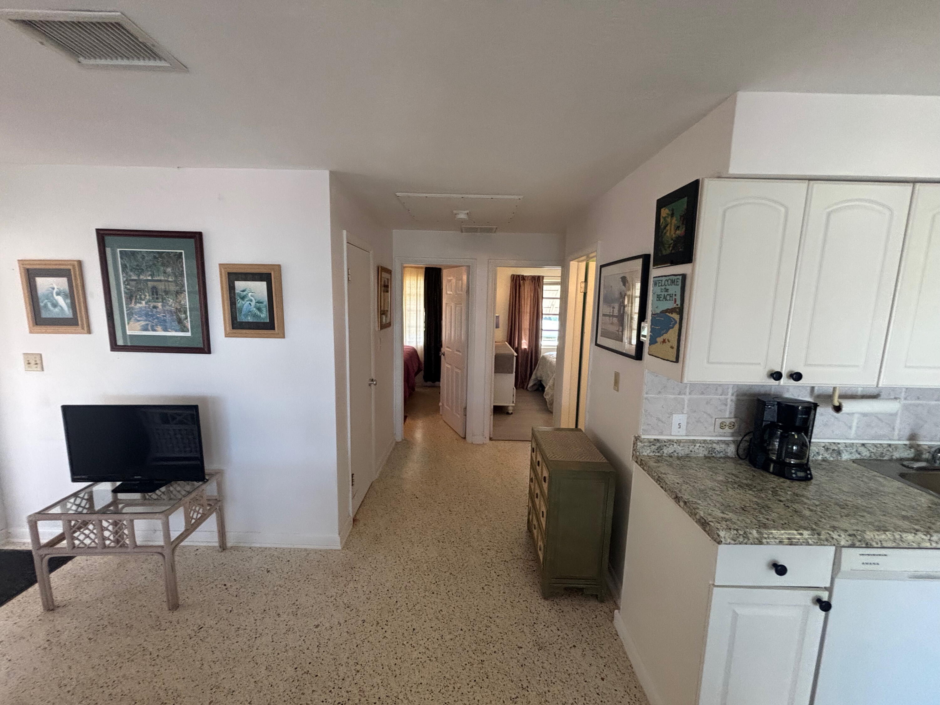 1433 Sunset Road Big Pine Key, FL 33043 - Photo 5 of 18 a living room with granite countertop furniture and a flat screen tv