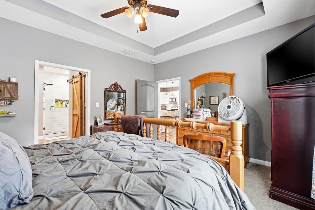 133 Pebblebrook Way Temple, GA 30179 - Photo 15 of 36 a bedroom with a bed and a flat tv screen on dresser
