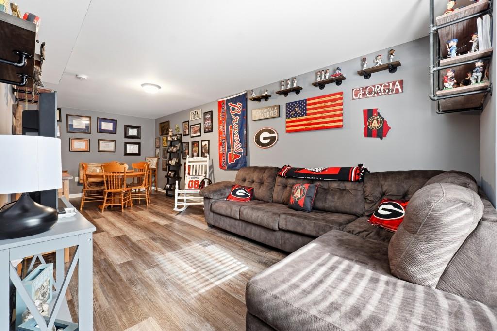 133 Pebblebrook Way Temple, GA 30179 - Photo 27 of 36 a living room with furniture a rug and a flat screen tv