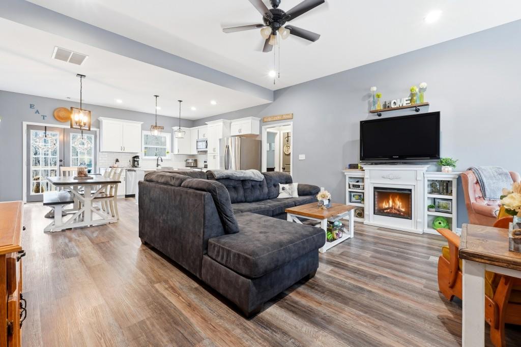 133 Pebblebrook Way Temple, GA 30179 - Photo 4 of 36 a living room with furniture a fireplace and a flat screen tv