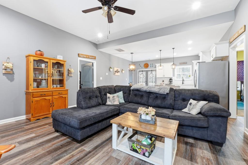 133 Pebblebrook Way Temple, GA 30179 - Photo 6 of 36 a living room with furniture and a chandelier