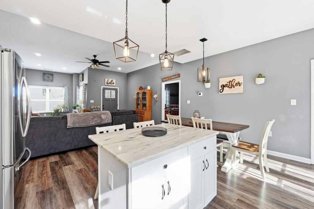 133 Pebblebrook Way Temple, GA 30179 - Photo 9 of 36 a view of a dining room and livingroom with furniture wooden floor a chandelier